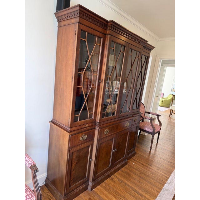 This beautiful breakfront bookcase cabinet by Hickory features banded mahogany inlay and elegant brass pulls. The top...