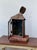A charming antique handcrafted punched tin and copper lantern featuring hand-cut starburst motifs, a hinged glass door,...