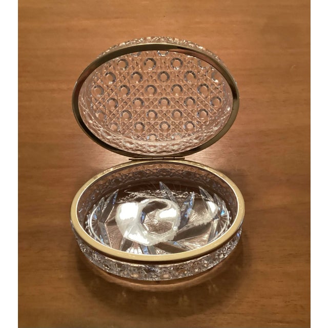 Early 20th century French Baccarat style crystal brass hinged box. Oval in shape. Measures 6” long, 3.75” wide; 3” tall....