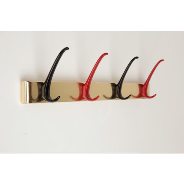 Vintage/Design 1950s German wall-mounted coat rack made of aluminum. Aluminum hooks with (likely) a Rilsan coating....