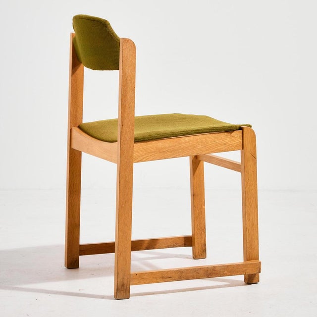 Stackable beech chair with textile seat and backrest from the 1980s. The surface of the chair has scratches and wear in...