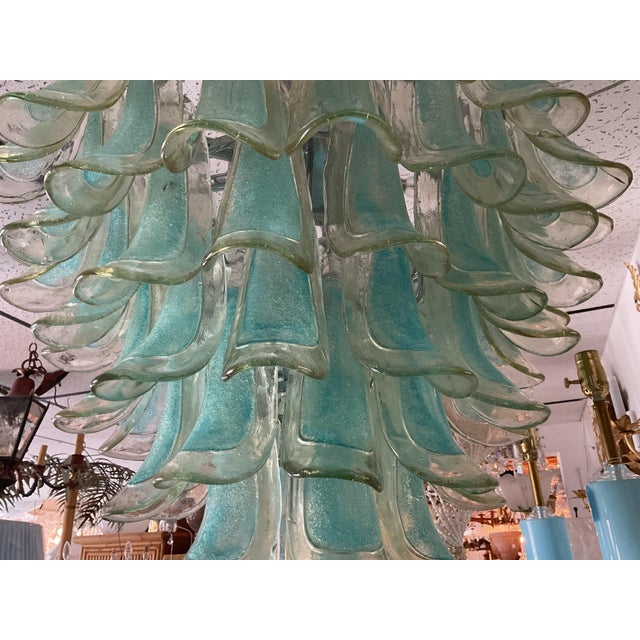 Bring dramatic elegance to your home with this breathtaking Murano-style chandelier featuring cascading hand-blown art...
