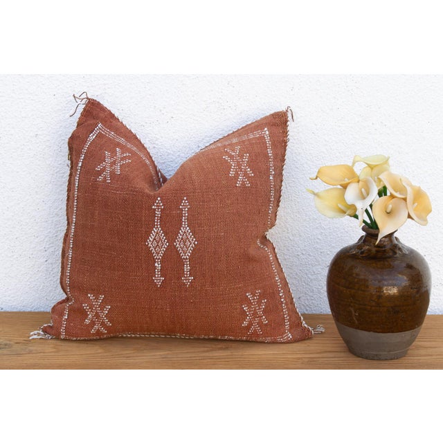 A vertical diamond column and star-marked corners give this handcrafted Moroccan cactus silk pillow quiet rhythm, hand-...