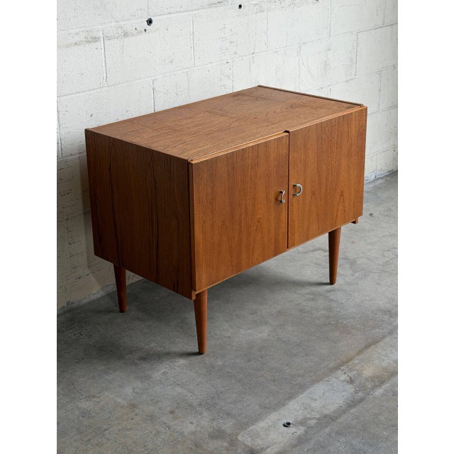This versatile storage piece presents a low-profile architectural silhouette with clean geometric lines. The twin cabinet...