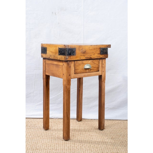 A small butcher's block table, early 20th century, French. Features a knife holder along one side and a single drawer with...
