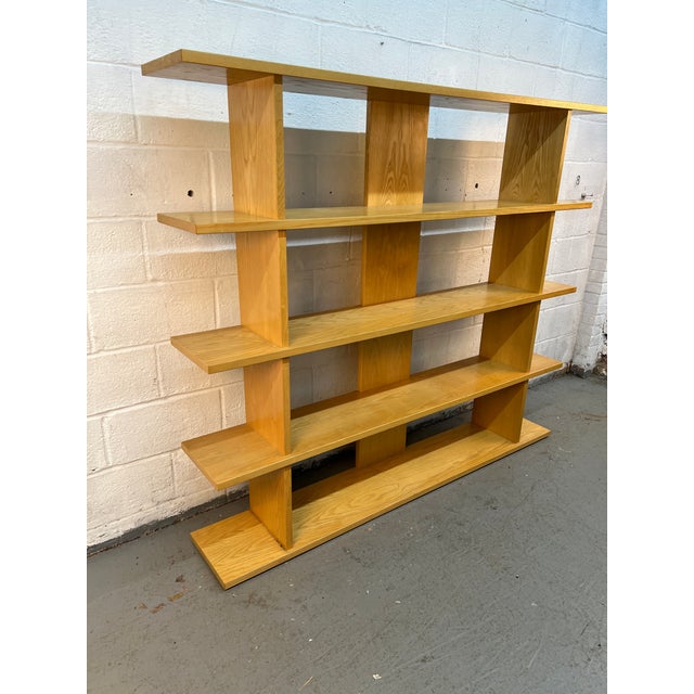 Stylish modern open shelving unit with a clean, minimalist design and beautiful natural wood finish. Features multiple...