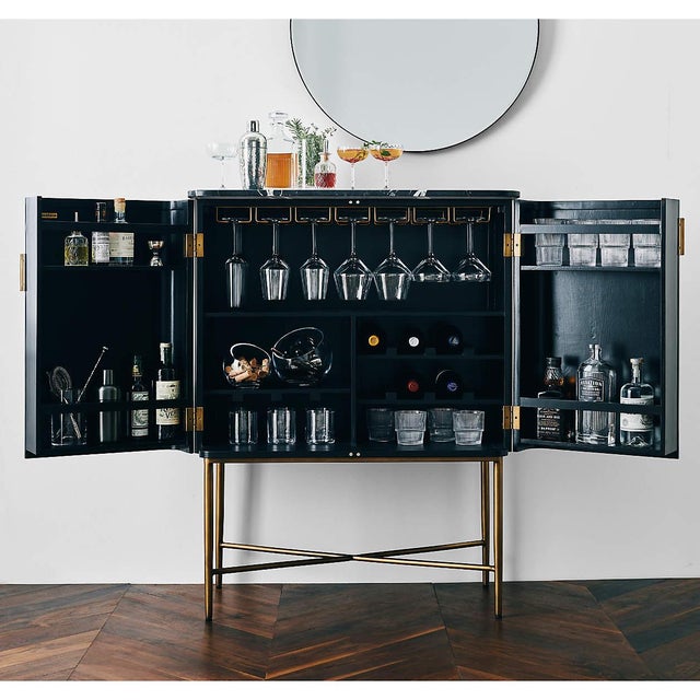 On-trend with a bit of French flair, our Fayette bookcase curves a stylish bar cabinet out of fluted and charcoal-finished...