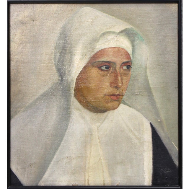 Striking portrait of a young nun, wearing a habit, and peering to the viewer’s right with big expressive eyes. Circa 1940,...