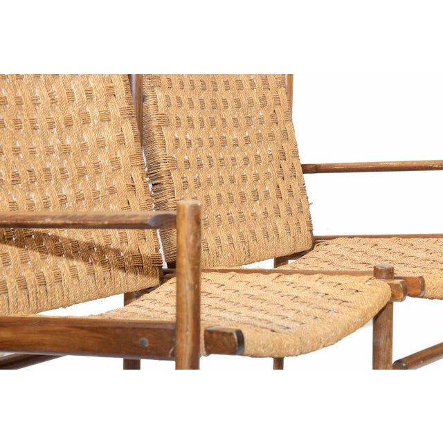 Two-seater sofa is a design furniture item realized by Artist of the mid-20th century. A vintage sofa realized in teak and...