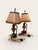 Pair of miniature 19th century French bronze flame and urn fragment lamps. Each features an urn-form bronze body raised on...