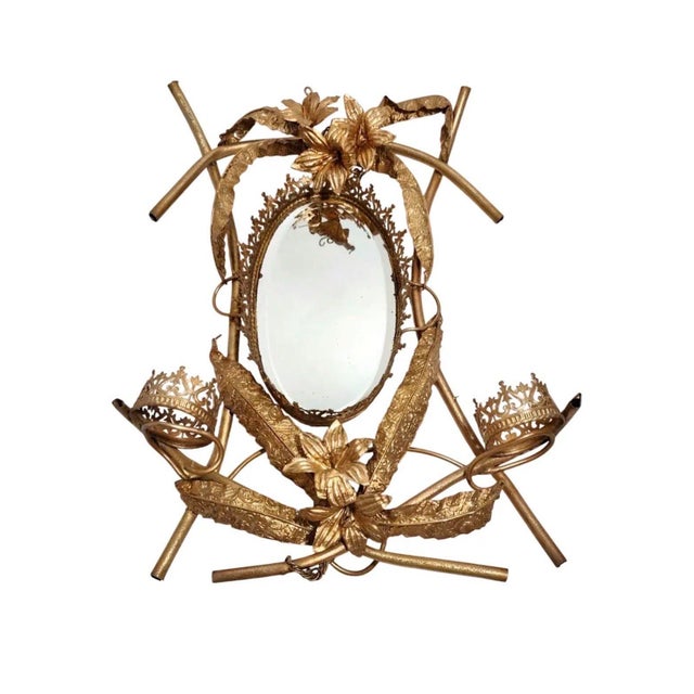 Exquisite Gilted metal mirror fit for a princess. Featuring crowns and intricate floral details, this is an exquisite one...