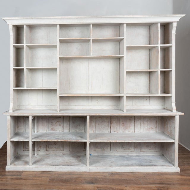 19th century large bookcase display cabinet from Denmark, crafted in pine. The cabinet has a newer white and gray painted...