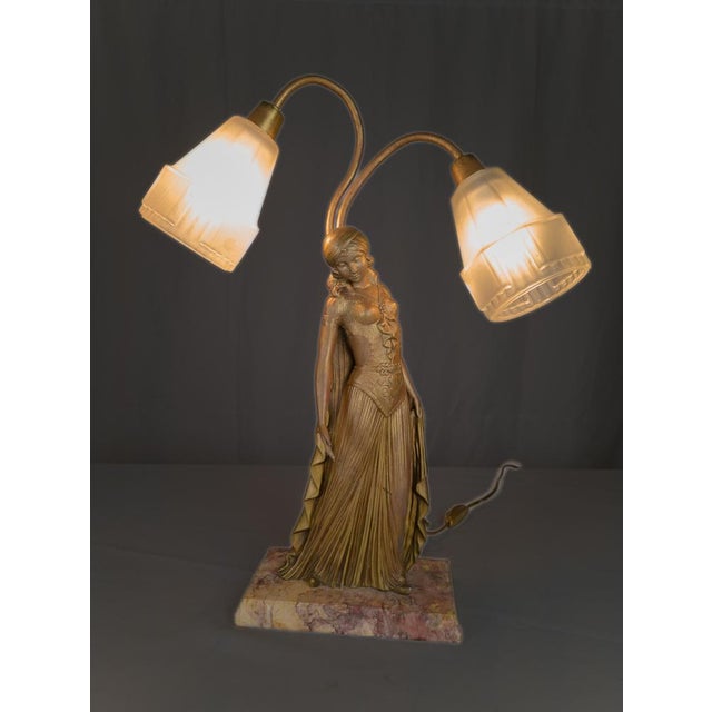 This Art Deco table lamp features a sculptural female figure by renowned artist Georges Van De Voorde. The statue, signed...