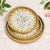 This set of three round decorative trays is handmade by Vietnamese craftsmen. The outer ring is woven with natural rattan,...