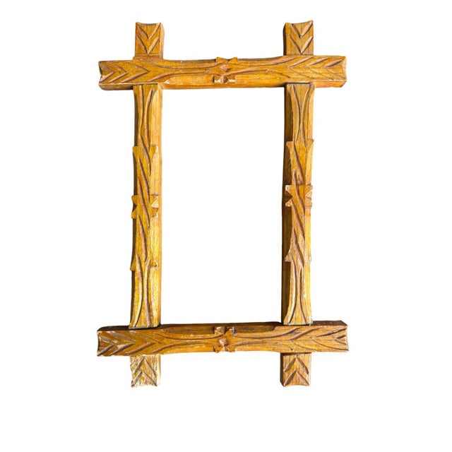 This product is a pair of antique Black Forest frames with a folk art design. Made of wood, the frames feature a brown...