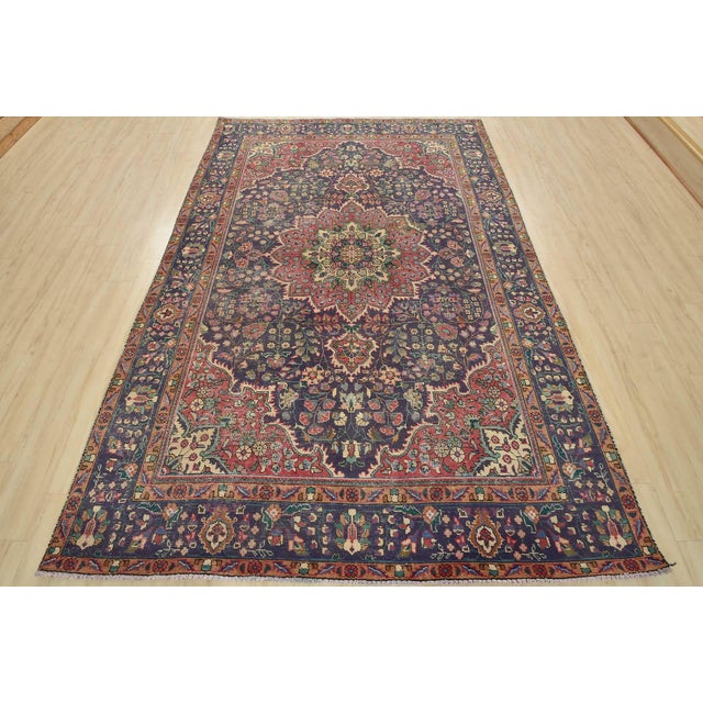 An authentic vintage traditional Tabriz rug hand-knotted with fine wool and natural dyes. This oriental rug features a...