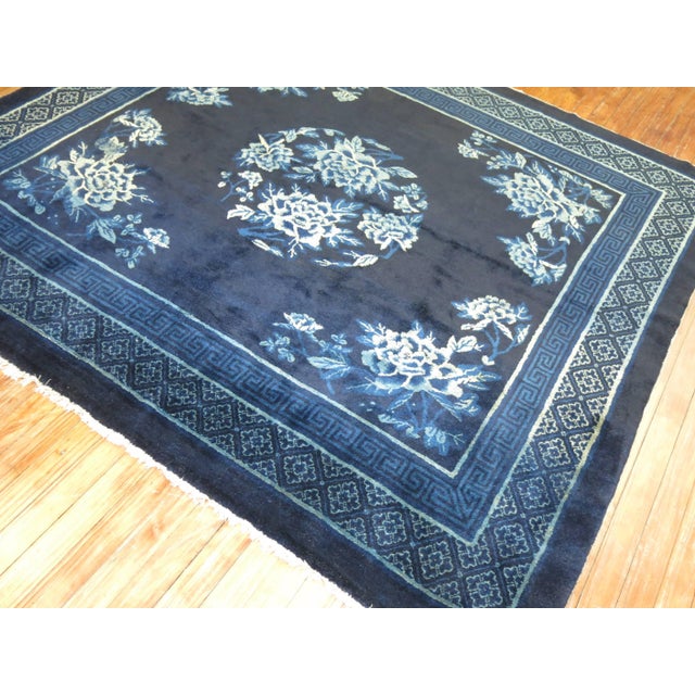A vintage Chinese square rug in predominant shades of midnight blue. The wool is very soft and all the colors are natural....