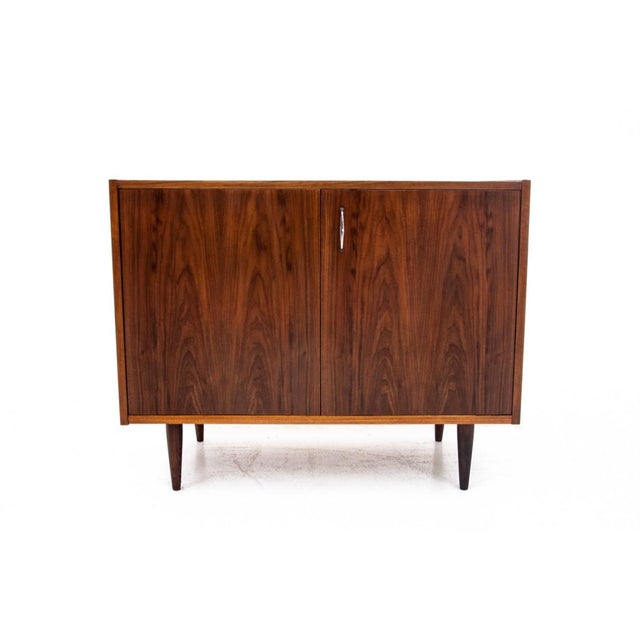 Teak chest of drawers from the 1960s, made in Denmark. The chest of drawers has one spacious space with one shelf. The...