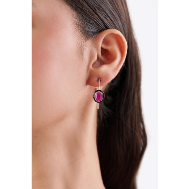 These Art Deco-style hoop earrings feature 3.19 carats of natural oval rubies, set in 14K white gold. Each measuring 8 x 6...
