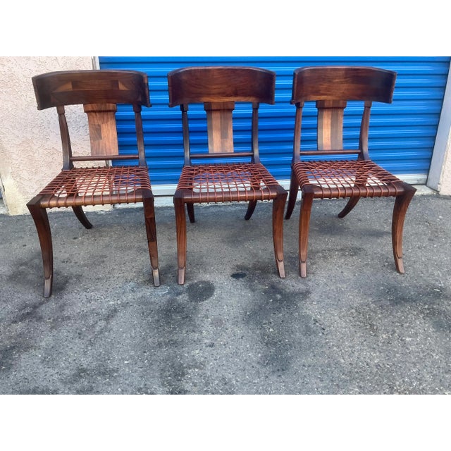 Klismos modern walnut chairs. Chairs are made of solid walnut and have a natural walnut finish. Chairs are in beautiful...