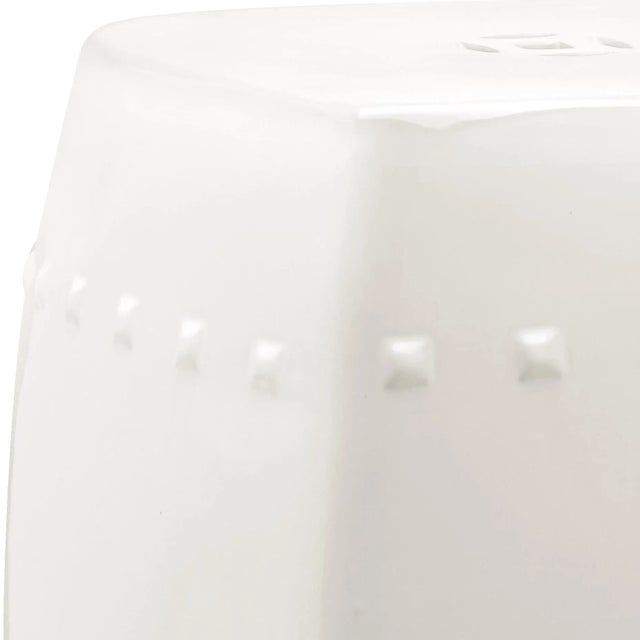 Clean, transitional styling defines the garden stool in cream ceramic.Crafted with traditional nailhead detailing and flat...