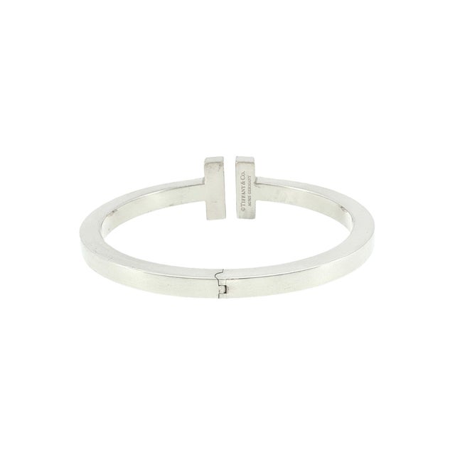 A 21st-century sterling silver hinged cuff bracelet by Tiffany & Co. This piece features a sleek, minimalist design with a...