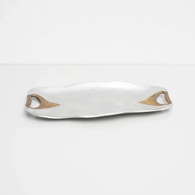 Mid-Century Modern decorative metal tray, by an unknown designer. Manufactured in Spain, circa 1950. In good original...