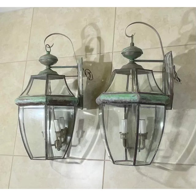 Elegant pair of wall lantern hand crafted from solid brass with three 40/watt lights each. Suitable for wet locations,...