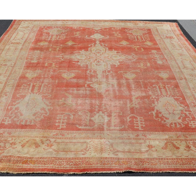 Measures: 11'5 x 15'0 Antique Turkish Oushak Rug with Soft Apricot Field and Faded Cream 11'5 x 15'0. Keivan Woven Arts /...