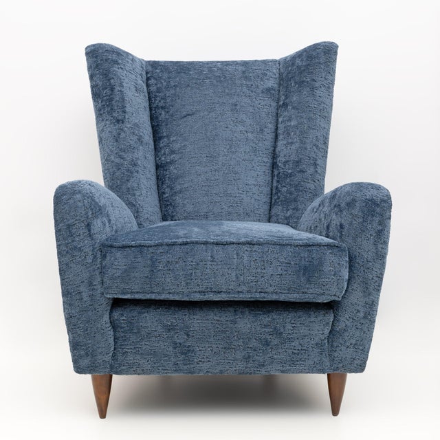 Beautiful armchair with curved armrests, made by Paolo Buffa in 1950. The curved and padded wooden structure, the covering...