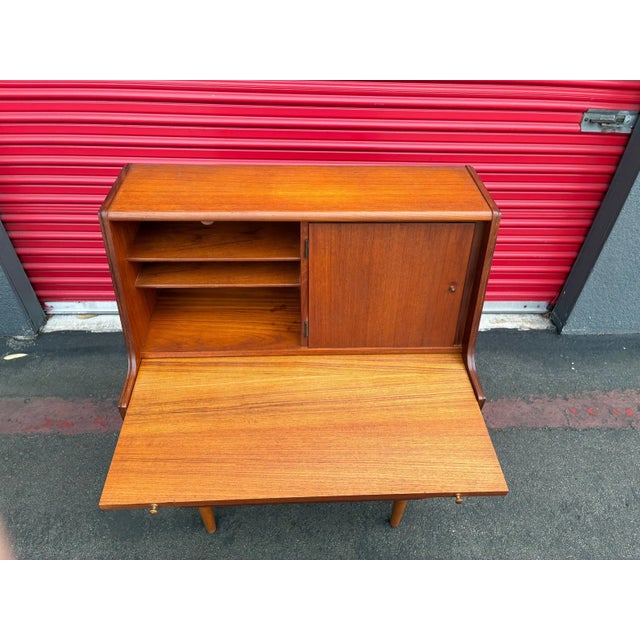 For sale is a lovely Mid century danish secretary desk in teak. This piece features 3 drawers that pull out smoothly and...