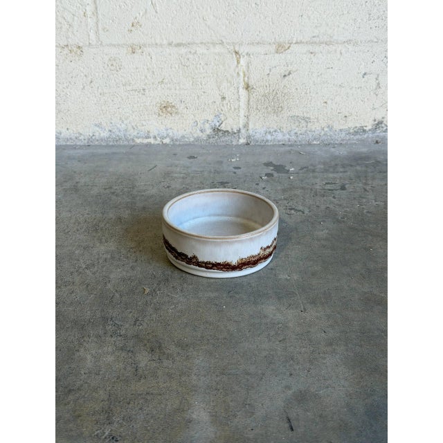 This charming, small ceramic bowl captures the quintessential rustic minimalism of European mid-century production. Shape-...