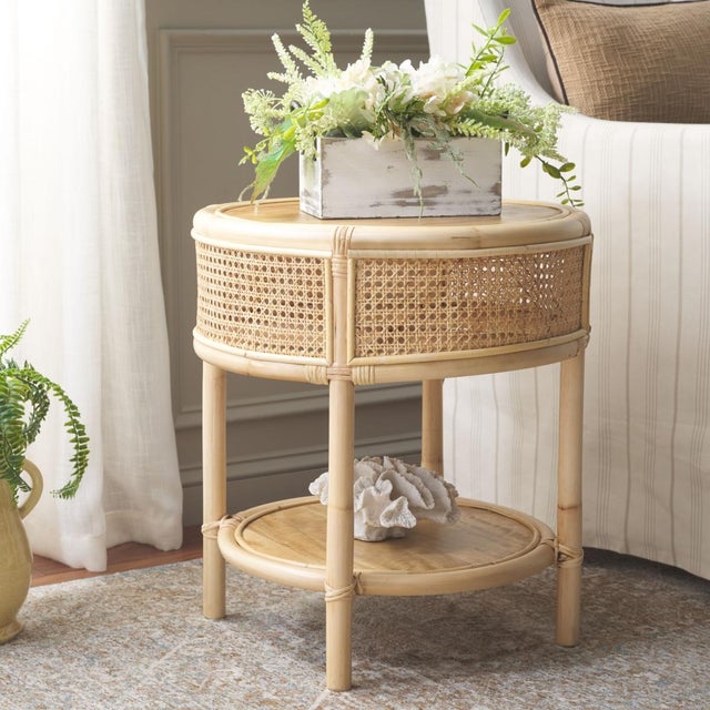 Introducing the Arvid Round Accent Table, exquisitely crafted from the Wood and Rattan materials. A perfect blend of...
