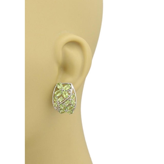 These exquisite Peridot & Diamonds semi-hoop earrings are a fine example of classic sophistication. Crafted in 14k white...