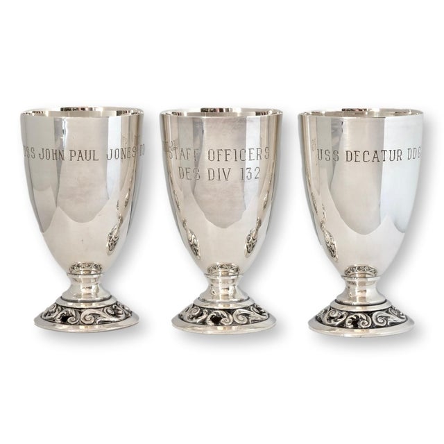 A rare and historically rich set of twelve U.S. Navy silver-plate goblets, each individually engraved with the name of a...