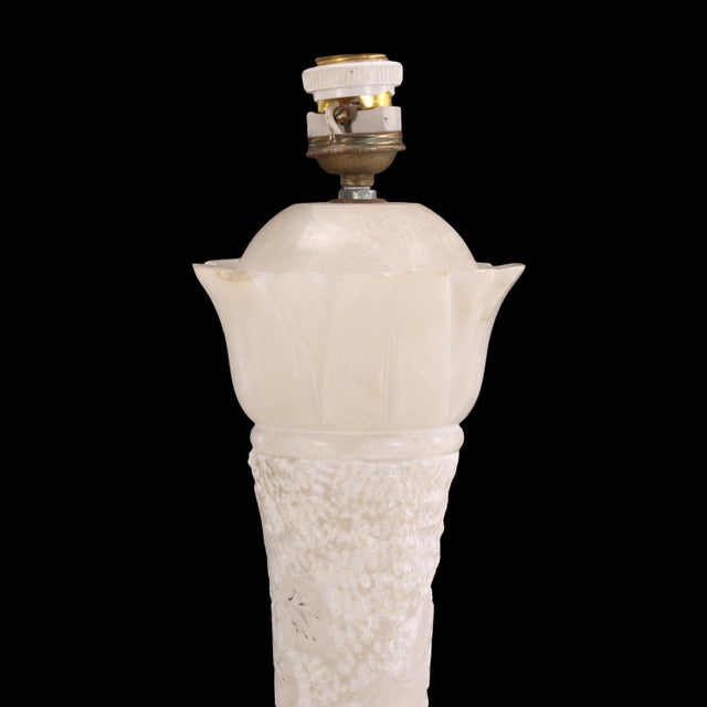 The sculptural form highlights the translucency and natural veining of the alabaster, combining refined craftsmanship with...