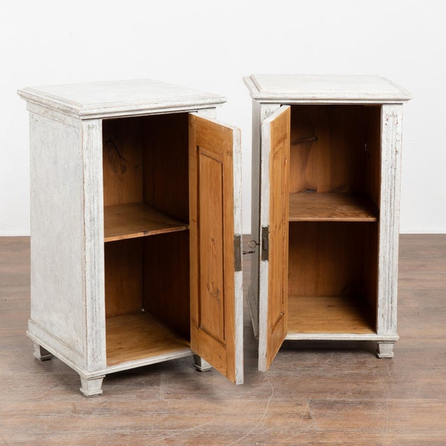 19th-century Swedish Gustavian pair of narrow pine cabinets, well suited for use as nightstands or small storage pieces....
