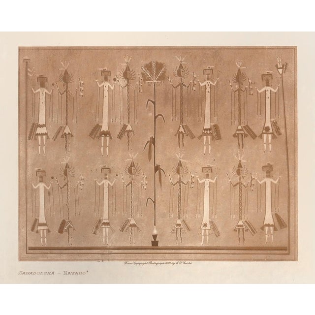 An original photogravure from Edward S. Curtis's The North American Indian. Zahadolzhá reproduces a Navajo dry painting,...