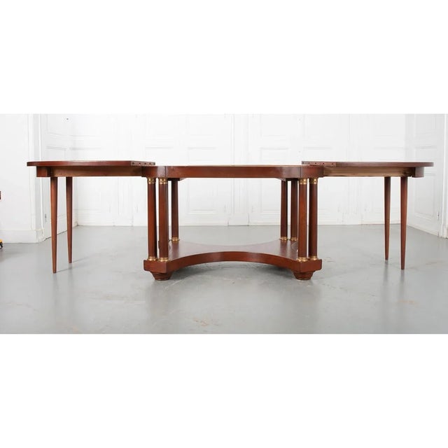 This oblong, Empire style mahogany table would be perfect as a dinning or center table. It has the ability to extend to...