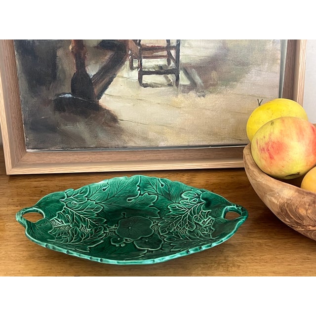 Antique majolica bread basket and two wall plates, all made in England around the 1920's. They are in the same green tone...