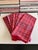 Set of nine vintage plaid cloth napkins in a classic red tartan-style pattern with green, blue, black, and white accents....