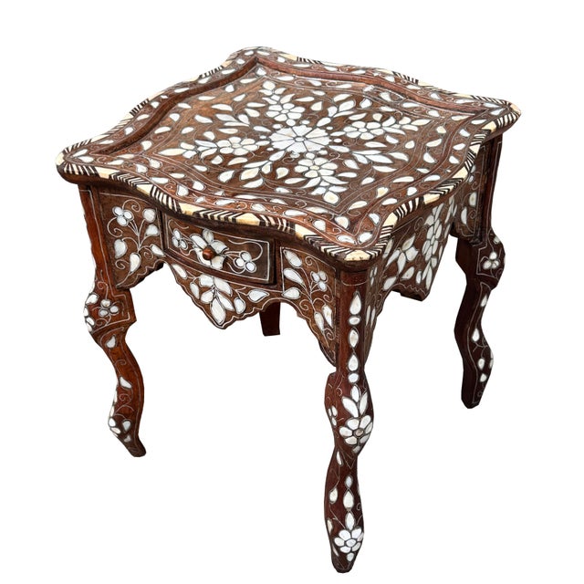 Exquisite antique Middle Eastern side table featuring an intricate floral design in natural mother-of-pearl inlay. Each...