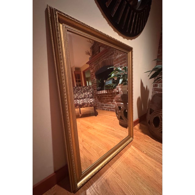 Elegant vintage La Barge wall mirror featuring a richly detailed gold gilt frame with classic traditional styling. The...