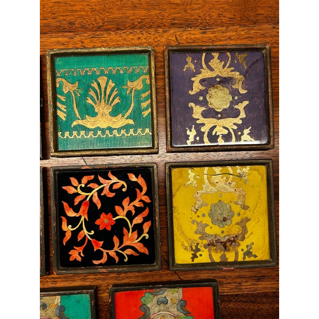 Set of 8 wood framed verre eglomise handpainted plaques in multicolor and gold featuring classical Venetian designs. Each...