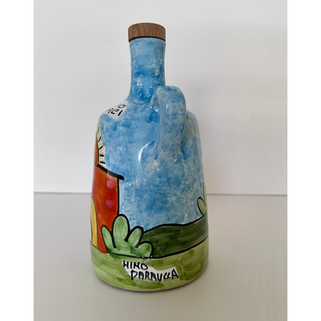 Nino Parrucca for Olio Geraci hand painted ceramic olive oil cruet with bucolic images. Parrucca created a line of pieces...