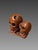 Netsuke at momento mori, Japan, Meiji era, 19th century. Depicts two skulls resting on bones. Signed under the base....