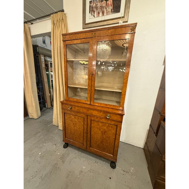 Design Plus Gallery presents an Antique Burl Wood Bookcase/Cabinet, Circa 1815. This antique burl wood bookcase/cabinet...