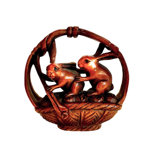 This collection consists of nine miniature Japanese netsuke figures, crafted from Japanese boxwood. The unifying focus is...