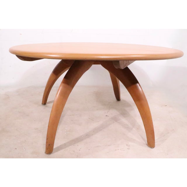 Iconic Heywood Wakefield Lazy Susan coffee table with arched wishbone legs. The table features a circular disk form top...