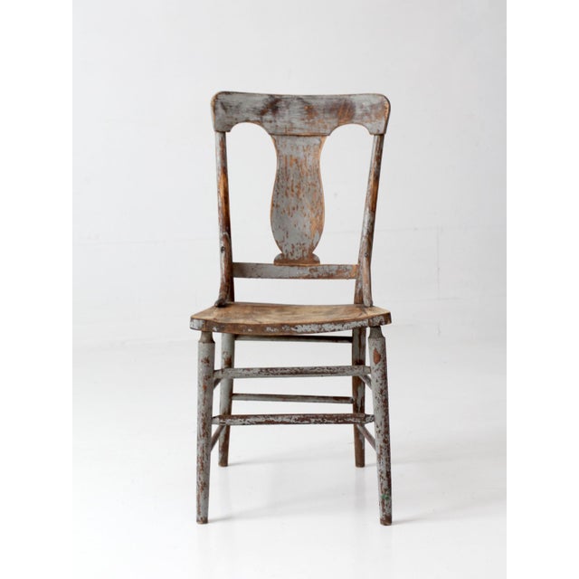 Antique 19th-century American country chair with a graceful lyre-shaped back and tall, slender profile. Faded gray-blue...